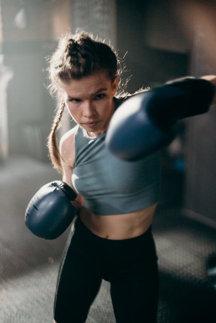 Woman in Blue Sports Bra and Black Leggings Doing Exercise